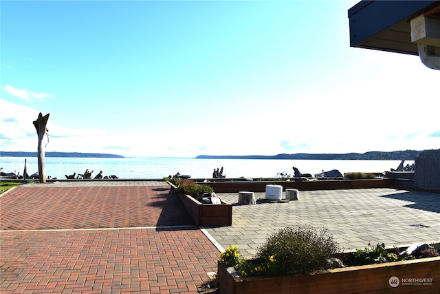 view of patio featuring a water view