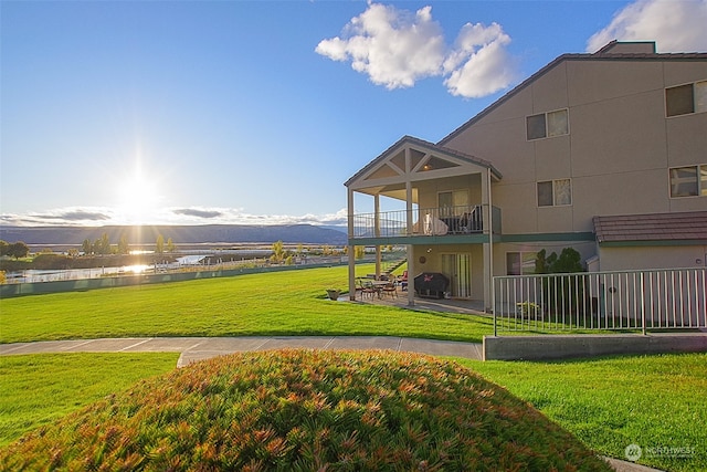 view of home's community featuring a yard and a water and mountain view