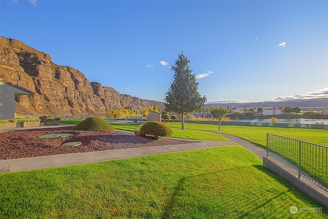 view of yard featuring a water and mountain view