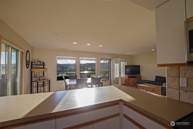 kitchen featuring white cabinetry and backsplash