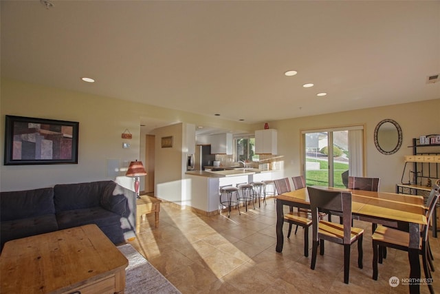 dining room with recessed lighting and light tile patterned floors