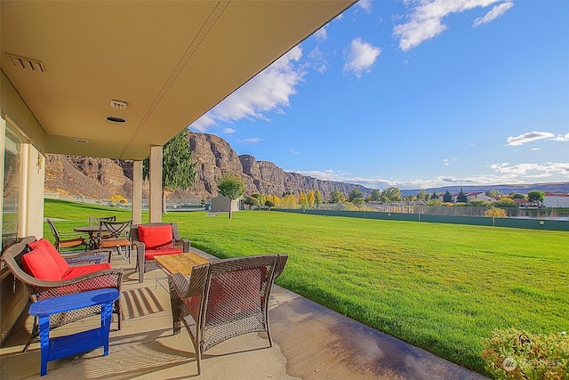 view of patio with a water and mountain view