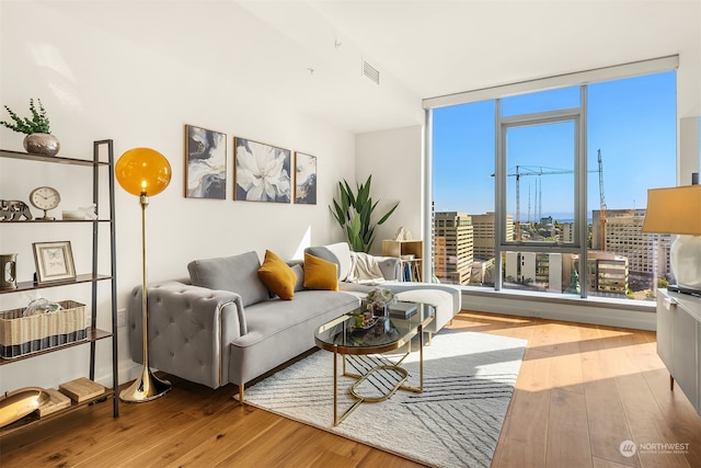 living room with a healthy amount of sunlight and hardwood / wood-style floors