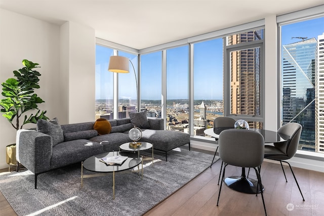 living room featuring a wall of windows, hardwood / wood-style flooring, and plenty of natural light