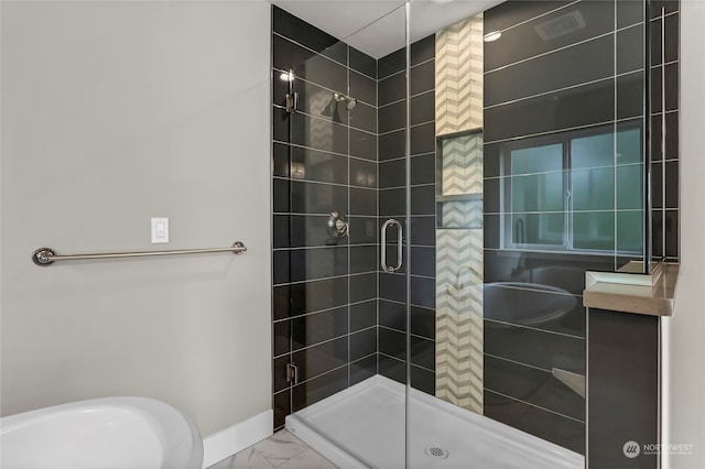 bathroom with a shower with door