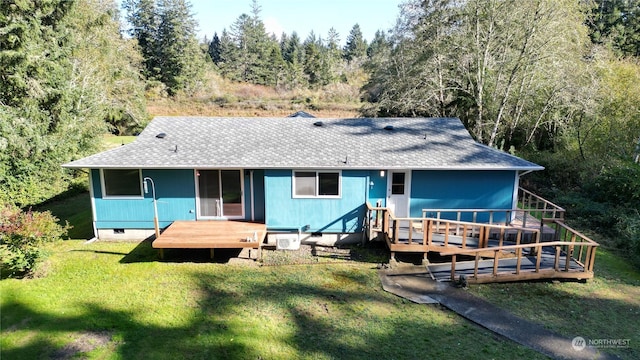 15614 Birch St, Long Beach, WA 98631 - rear view of property with roof with shingles, a wooded view, a wooden deck, a yard, and crawl space
