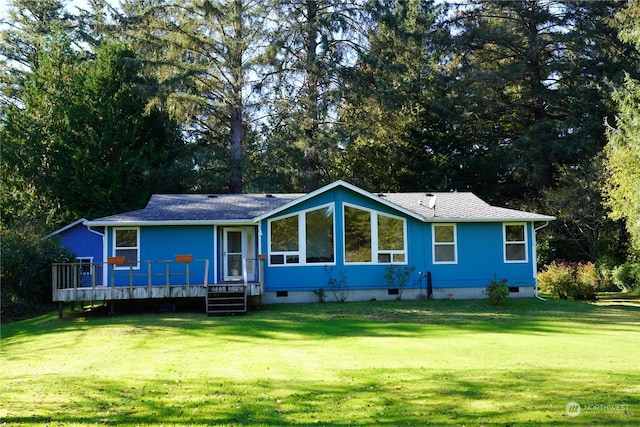 back of property with a yard and a deck