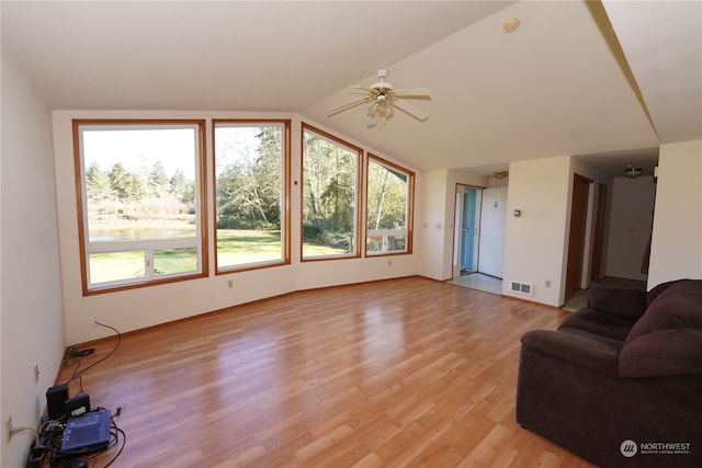 living room featuring lofted ceiling, light wood-type flooring, and ceiling fan