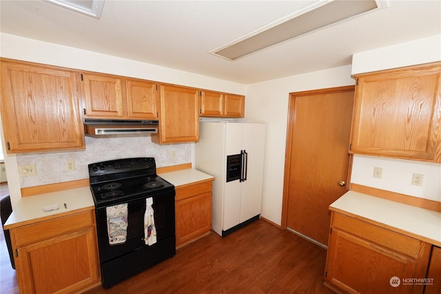15614 Birch St, Long Beach, WA 98631 - kitchen with dark wood-style floors, black range with electric stovetop, range hood, light countertops, and white fridge with ice dispenser