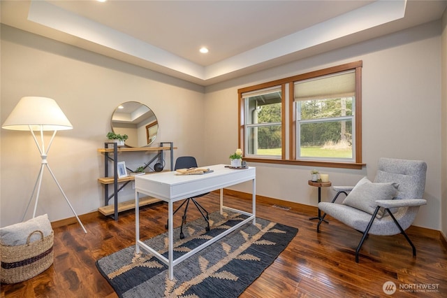 office featuring a tray ceiling, recessed lighting, baseboards, and wood finished floors