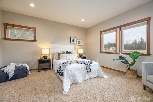 carpeted bedroom featuring recessed lighting, visible vents, and baseboards