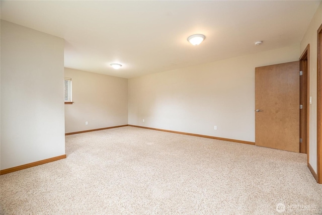 carpeted empty room with baseboards