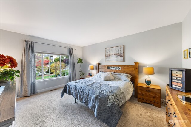 bedroom with light colored carpet