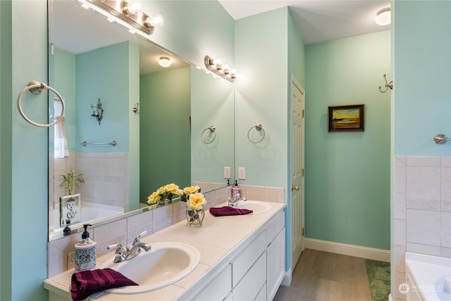 bathroom featuring a bath, vanity, and hardwood / wood-style floors