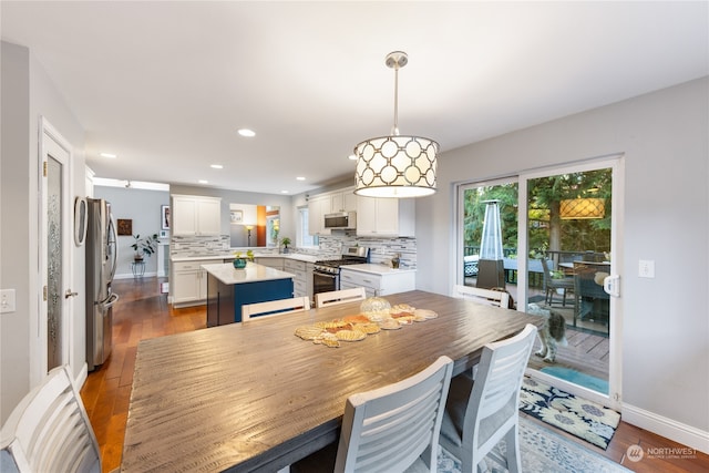 dining space with wood-type flooring