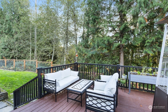 wooden deck with a lawn and an outdoor hangout area