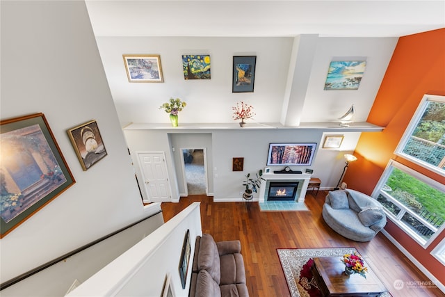 living room with dark hardwood / wood-style floors and beam ceiling