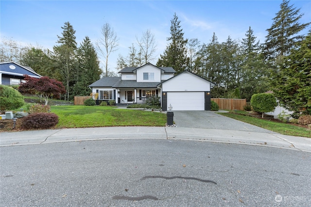 front of property with a front yard, a porch, and a garage