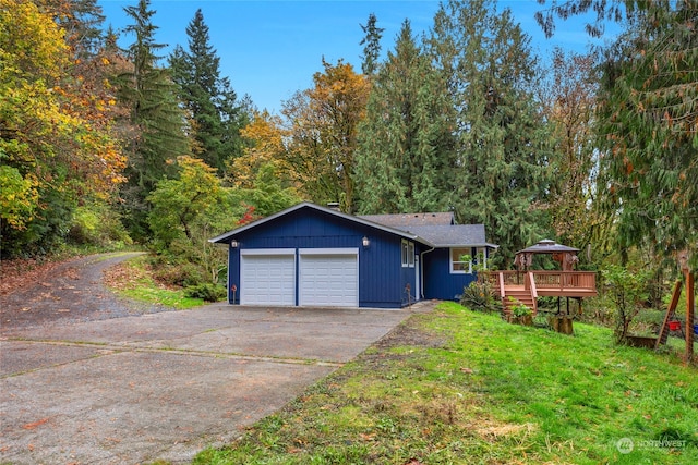 view of front of home with a deck and a garage