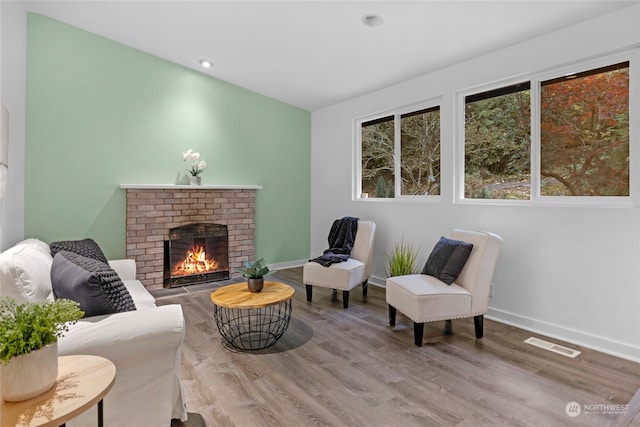 sitting room featuring a fireplace and wood-type flooring