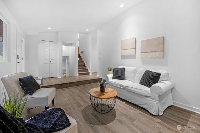 living room with lofted ceiling and hardwood / wood-style floors