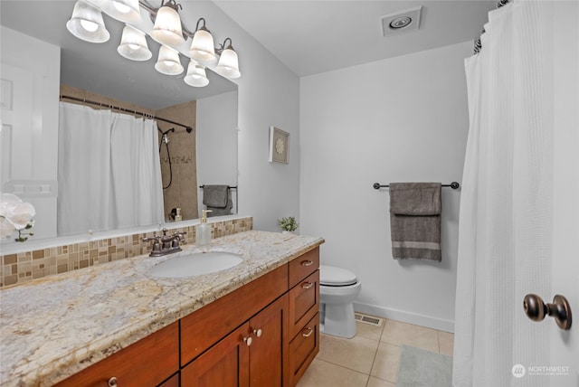 bathroom featuring backsplash, a shower with shower curtain, toilet, tile patterned floors, and vanity