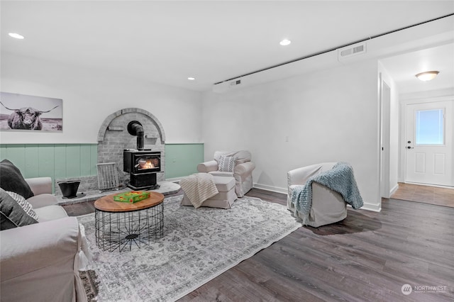 living room with wood-type flooring and a wood stove