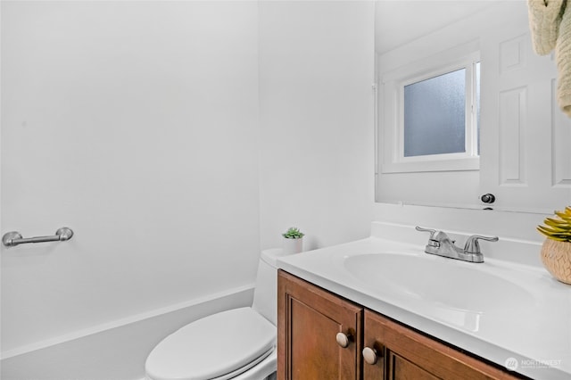 bathroom featuring toilet and vanity