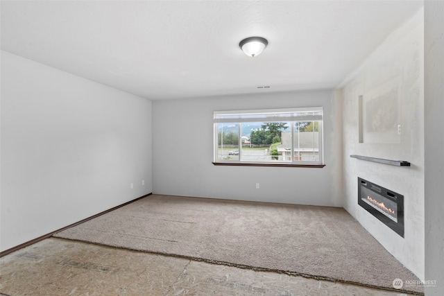 unfurnished living room featuring carpet flooring