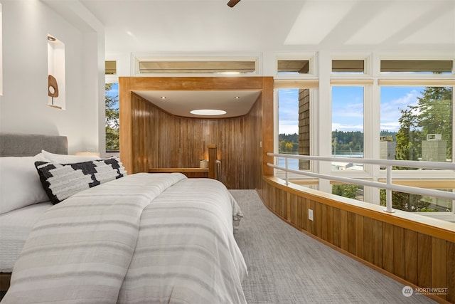 bedroom featuring wooden walls