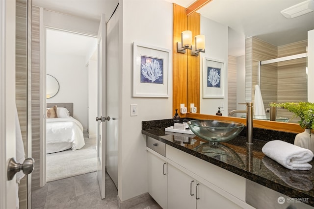 bathroom with vanity and a shower with shower door