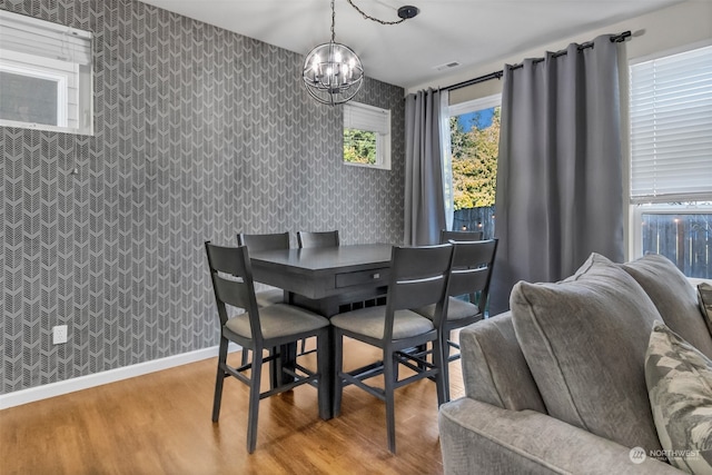 dining area with a chandelier and light hardwood / wood-style floors