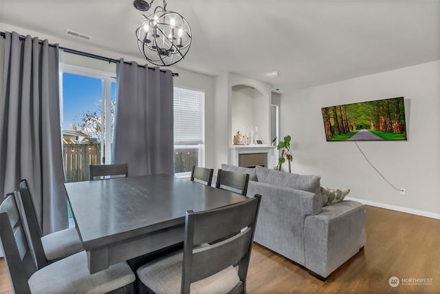 dining area featuring an inviting chandelier and wood-type flooring