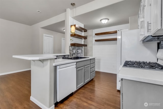 kitchen featuring white appliances, gray cabinetry, sink, decorative light fixtures, and dark wood-type flooring