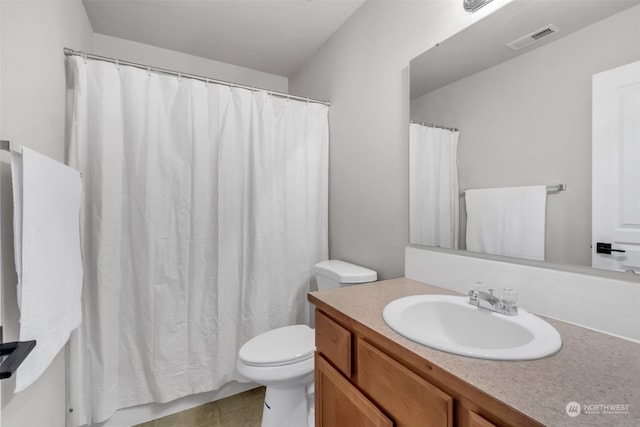 bathroom with vanity, a shower with curtain, toilet, and tile patterned floors