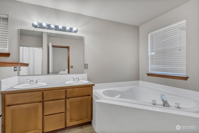 bathroom featuring vanity, a relaxing tiled tub, and tile patterned floors