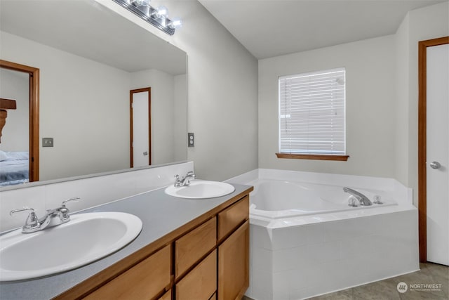 bathroom with vanity, tiled bath, and tile patterned floors