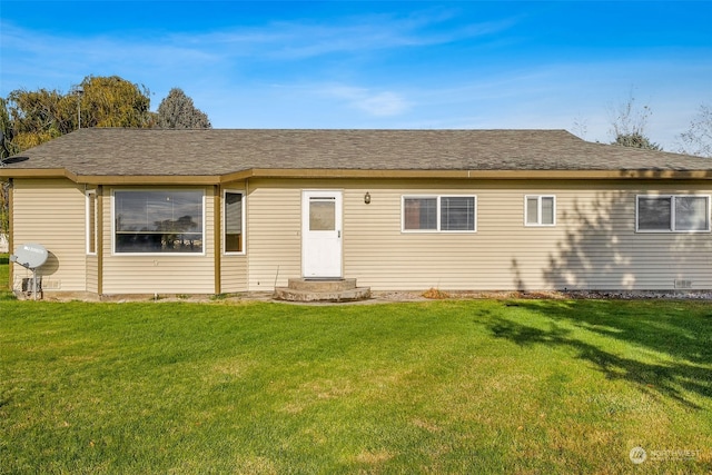 back of property featuring a lawn