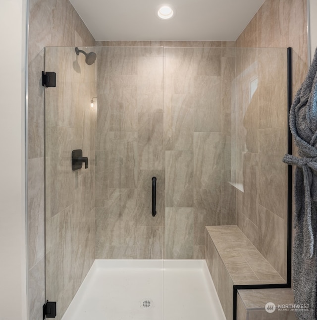 bathroom with a shower with door