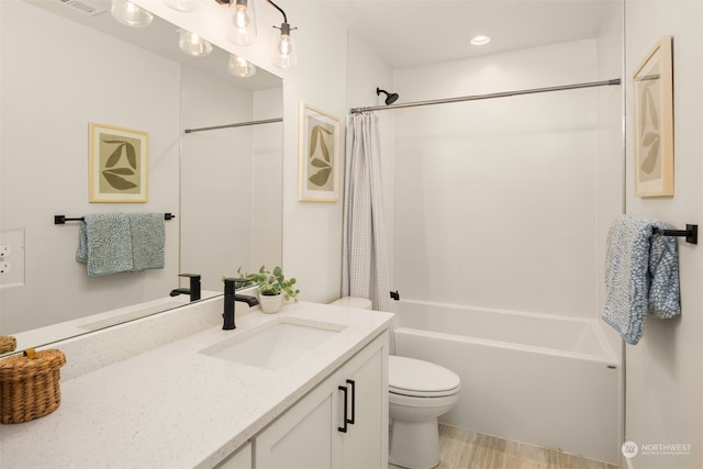 full bathroom with vanity, shower / bath combination with curtain, and toilet