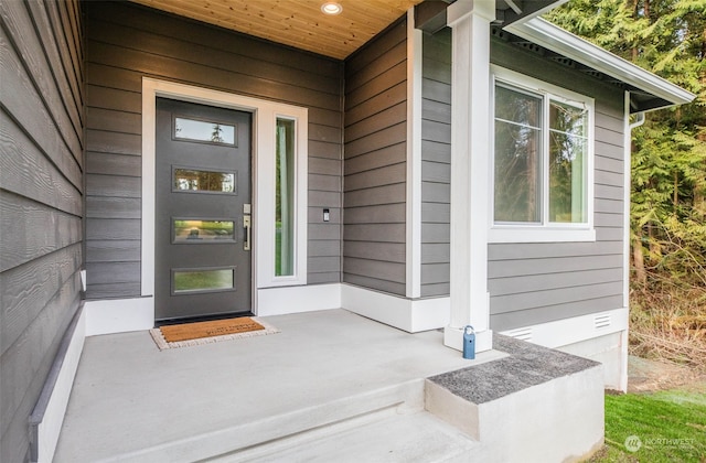 view of exterior entry with covered porch