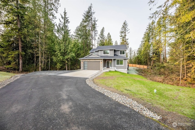 view of property featuring a garage and a front yard