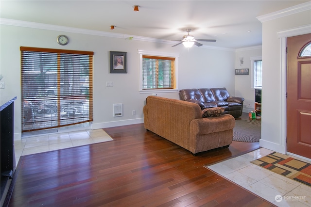 living room featuring ornamental molding, wood-type flooring, heating unit, and ceiling fan