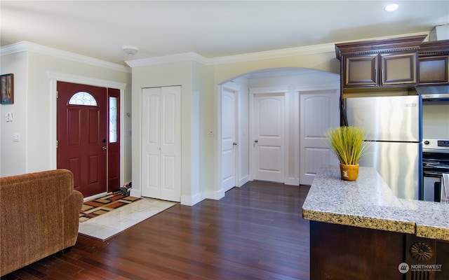 entryway featuring ornamental molding and dark hardwood / wood-style flooring