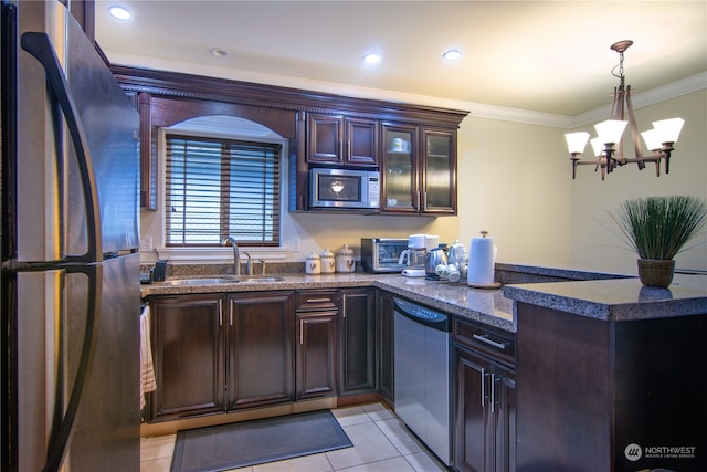 kitchen with ornamental molding, pendant lighting, an inviting chandelier, light tile patterned floors, and appliances with stainless steel finishes