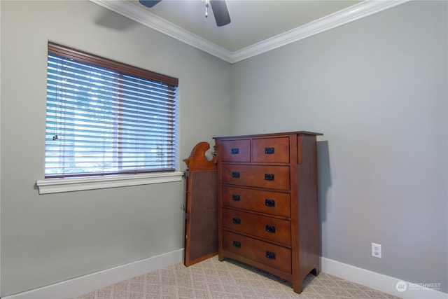 carpeted bedroom with ornamental molding and ceiling fan