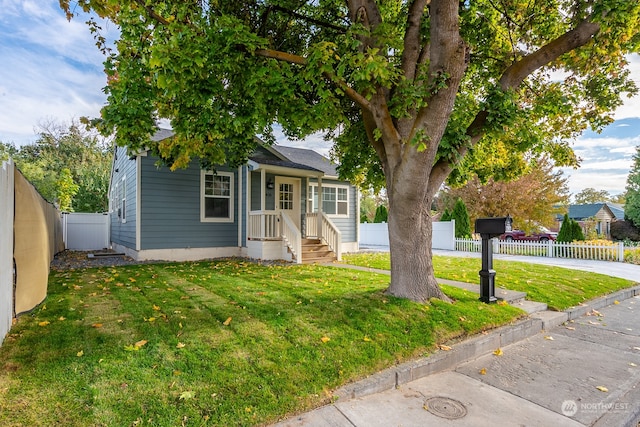 obstructed view of property with a front lawn