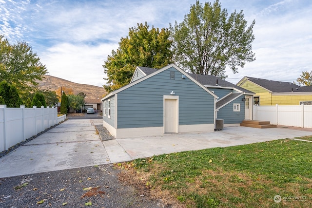 garage with cooling unit and a lawn