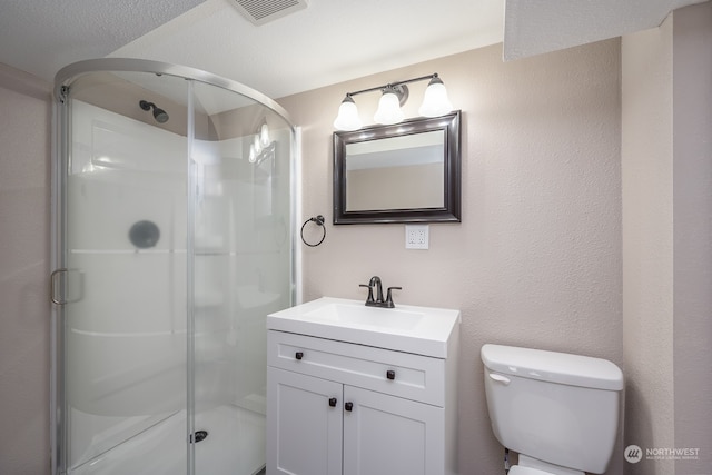 bathroom with vanity, a textured ceiling, toilet, and an enclosed shower