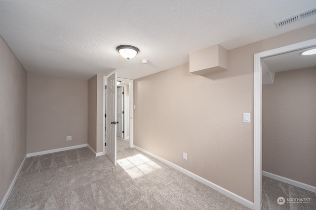 interior space featuring carpet flooring and a textured ceiling